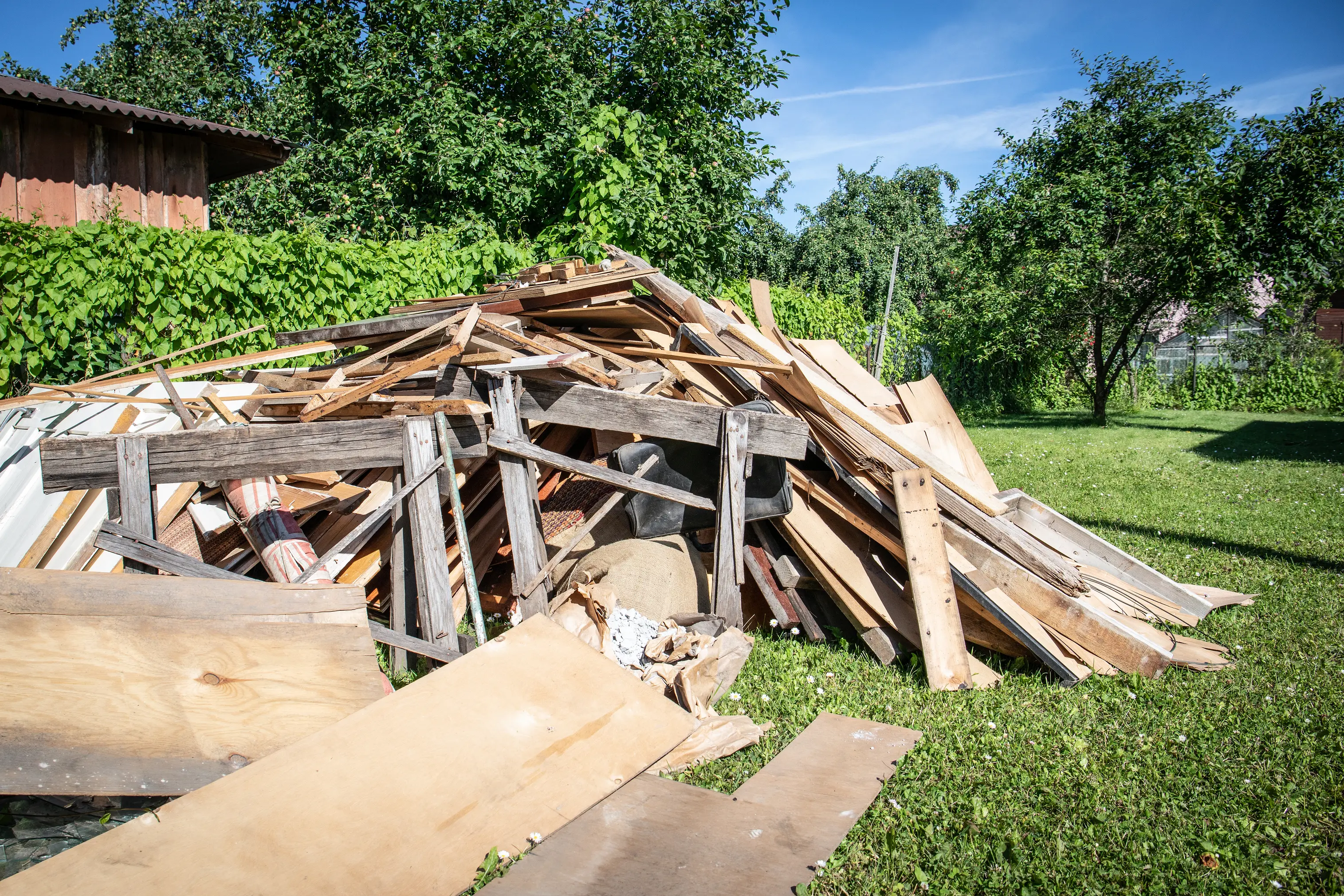 Wooden debris at the yard, boards and plates. Construction and reconstruction concept.