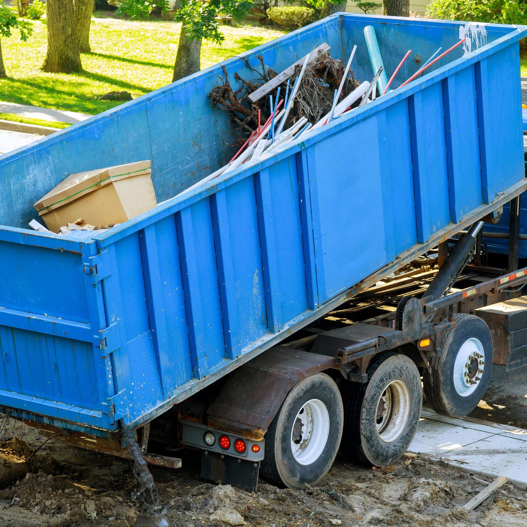Loading the garbage container old and used construction material in the new building construction work site. Loading the garbage container construction material and used in the container new building frame of a new house under construction